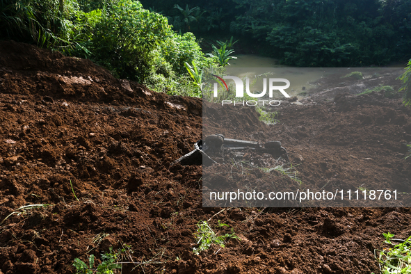 A car is plunging into a ravine after a landslide disaster on the Bogor-Ciawi-Sukabumi (Bocimi) toll road in Bogor, Indonesia, on April 4, 2...