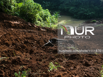 A car is plunging into a ravine after a landslide disaster on the Bogor-Ciawi-Sukabumi (Bocimi) toll road in Bogor, Indonesia, on April 4, 2...