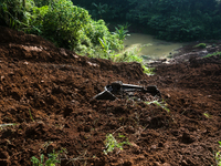 A car is plunging into a ravine after a landslide disaster on the Bogor-Ciawi-Sukabumi (Bocimi) toll road in Bogor, Indonesia, on April 4, 2...