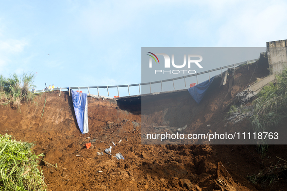 A car is plunging into a ravine after a landslide disaster on the Bogor-Ciawi-Sukabumi (Bocimi) toll road in Bogor, Indonesia, on April 4, 2...