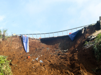 A car is plunging into a ravine after a landslide disaster on the Bogor-Ciawi-Sukabumi (Bocimi) toll road in Bogor, Indonesia, on April 4, 2...