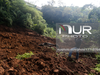 A car is plunging into a ravine after a landslide disaster on the Bogor-Ciawi-Sukabumi (Bocimi) toll road in Bogor, Indonesia, on April 4, 2...