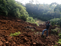 A car is plunging into a ravine after a landslide disaster on the Bogor-Ciawi-Sukabumi (Bocimi) toll road in Bogor, Indonesia, on April 4, 2...