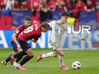 Arda Guler attacking midfield of Real Madrid and Turkey and Pablo Ibañez central midfield of Osasuna and Spain compete for the ball during t...