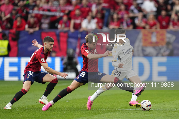 Arda Guler attacking midfield of Real Madrid and Turkey and Pablo Ibañez central midfield of Osasuna and Spain compete for the ball during t...