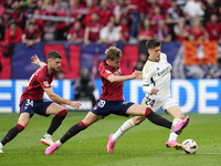 Arda Guler attacking midfield of Real Madrid and Turkey and Pablo Ibañez central midfield of Osasuna and Spain compete for the ball during t...