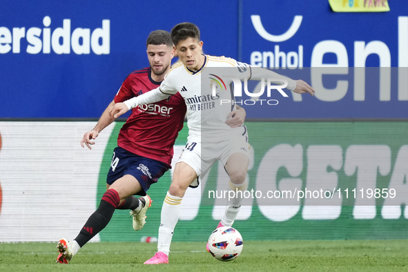 Arda Guler attacking midfield of Real Madrid and Turkey and Iker Muñoz defensive midfield of Osasuna and Spain compete for the ball during t...