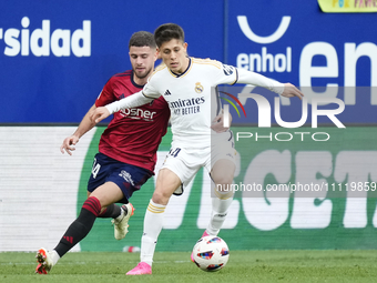 Arda Guler attacking midfield of Real Madrid and Turkey and Iker Muñoz defensive midfield of Osasuna and Spain compete for the ball during t...