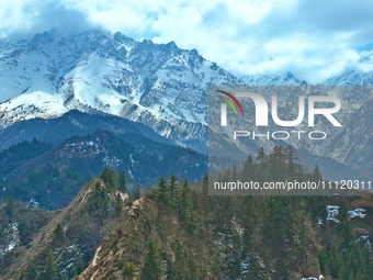 The snowy mountains are rising and falling in the Qilian Mountains National Park's horseshoe scenic area in Zhangye, China, on April 4, 2024...