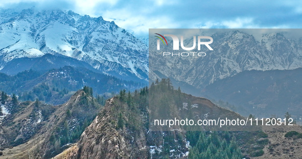 The snowy mountains are rising and falling in the Qilian Mountains National Park's horseshoe scenic area in Zhangye, China, on April 4, 2024...