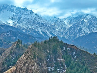 The snowy mountains are rising and falling in the Qilian Mountains National Park's horseshoe scenic area in Zhangye, China, on April 4, 2024...