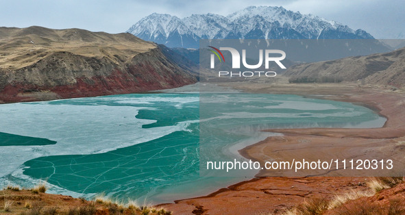 The snowy mountains are rising and falling in the Qilian Mountains National Park's horseshoe scenic area in Zhangye, China, on April 4, 2024...