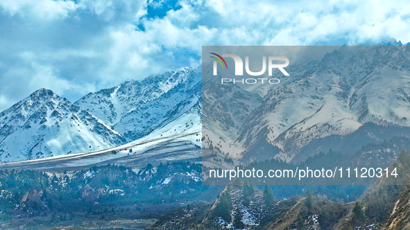 The snowy mountains are rising and falling in the Qilian Mountains National Park's horseshoe scenic area in Zhangye, China, on April 4, 2024...