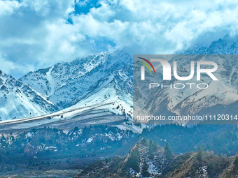 The snowy mountains are rising and falling in the Qilian Mountains National Park's horseshoe scenic area in Zhangye, China, on April 4, 2024...