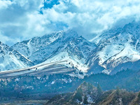 The snowy mountains are rising and falling in the Qilian Mountains National Park's horseshoe scenic area in Zhangye, China, on April 4, 2024...