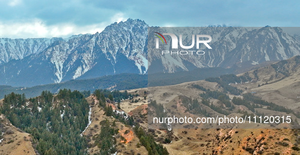 The snowy mountains are rising and falling in the Qilian Mountains National Park's horseshoe scenic area in Zhangye, China, on April 4, 2024...