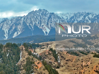 The snowy mountains are rising and falling in the Qilian Mountains National Park's horseshoe scenic area in Zhangye, China, on April 4, 2024...