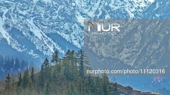 The snowy mountains are rising and falling in the Qilian Mountains National Park's horseshoe scenic area in Zhangye, China, on April 4, 2024...