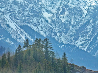 The snowy mountains are rising and falling in the Qilian Mountains National Park's horseshoe scenic area in Zhangye, China, on April 4, 2024...