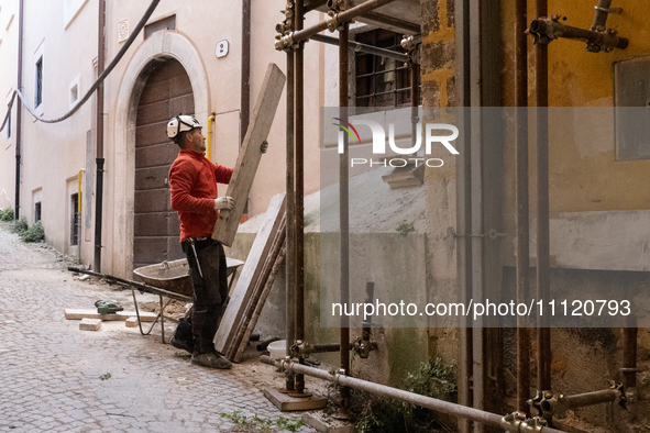 A worker on a building site and rebuilt buildings are seen in L'Aquila, Italy, on April 5th, 2024. on April 6th L'Aquila will commemorate it...