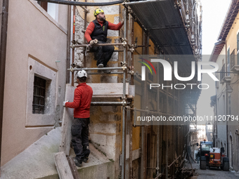 Workers on a building site and rebuilt buildings are seen in L'Aquila, Italy, on April 5th, 2024. on April 6th L'Aquila will commemorate its...