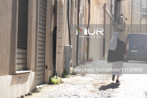 A nun walking around historic centre is seen in L'Aquila, Italy, on April 5th, 2024. on April 6th L'Aquila will commemorate its 15th anniver...