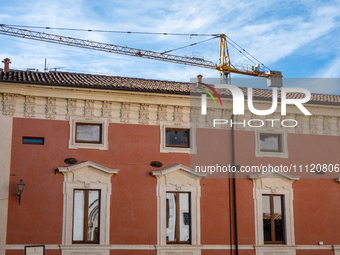 A rebuilt building and a crane are seen in L'Aquila, Italy, on April 5th, 2024. On April 6th L'Aquila will commemorate its 15th anniversary...