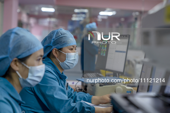 Doctors and nurses are providing medical services to seriously ill patients in an intensive care unit in Enshi, Hubei Province, China, on Ap...