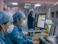 Doctors and nurses are providing medical services to seriously ill patients in an intensive care unit in Enshi, Hubei Province, China, on Ap...