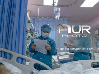 Two nurses are checking a patient before a blood transfusion in the intensive care unit in Enshi, Hubei Province, China, on April 5, 2024. (