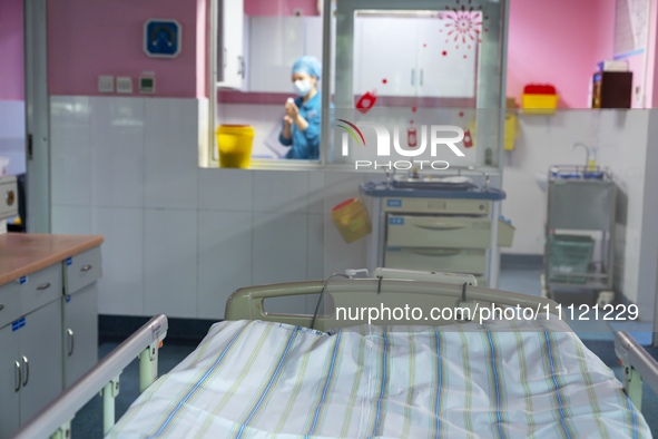 A nurse is dispensing medicine in an intensive care room in Enshi, Hubei Province, China, on April 5, 2024. 