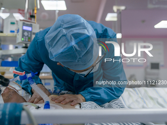 Doctors and nurses are providing medical services to seriously ill patients in an intensive care unit in Enshi, Hubei Province, China, on Ap...