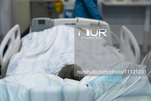 A patient is resting in an intensive care unit in Enshi, Hubei Province, China, on April 5, 2024. 