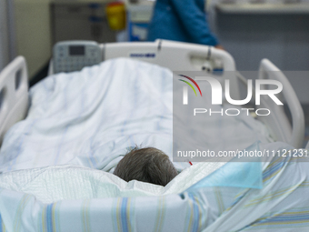 A patient is resting in an intensive care unit in Enshi, Hubei Province, China, on April 5, 2024. (