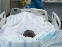 A patient is resting in an intensive care unit in Enshi, Hubei Province, China, on April 5, 2024. (