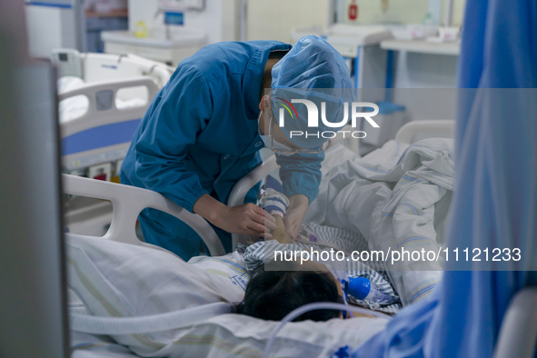 A nurse is providing intravenous infusion for a seriously ill patient in the intensive care unit in Enshi, Hubei Province, China, on April 5...