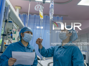 Two nurses are performing a blood transfusion for a patient in the intensive care unit in Enshi, Hubei Province, China, on April 5, 2024. (