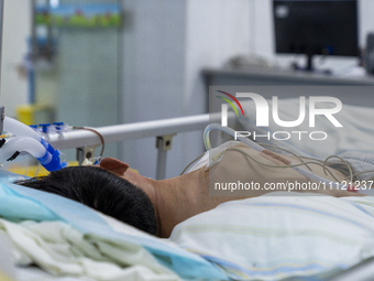 Patients are lying with tubes in an intensive care unit in Enshi, Hubei Province, China, on April 5, 2024. (