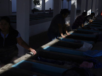 Women are washing clothes at a community laundry in Santa Cruz Acalpixca, Xochimilco, Mexico City. (