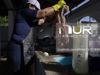 A woman is washing clothes at a community laundry in Santa Cruz Acalpixca, Xochimilco, Mexico City. (