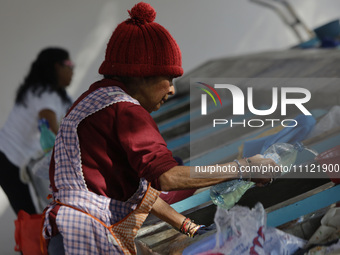 A woman is washing clothes at a community laundry in Santa Cruz Acalpixca, Xochimilco, Mexico City. (