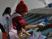 A woman is washing clothes at a community laundry in Santa Cruz Acalpixca, Xochimilco, Mexico City. (