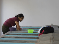 A woman is washing clothes at a community laundry in Santa Cruz Acalpixca, Xochimilco, Mexico City. (