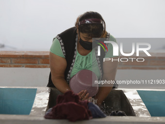 A woman is washing clothes at a community laundry in Santa Cruz Acalpixca, Xochimilco, Mexico City. (