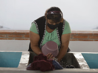 A woman is washing clothes at a community laundry in Santa Cruz Acalpixca, Xochimilco, Mexico City. (