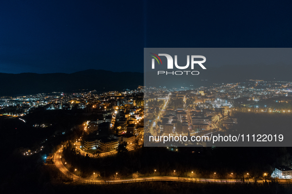 A blue light beam faced to the sky is seen in an aerial view in L'Aquila, Italy, on April 5th, 2024. On April 6th L'Aquila will commemorate...