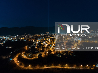 A blue light beam faced to the sky is seen in an aerial view in L'Aquila, Italy, on April 5th, 2024. On April 6th L'Aquila will commemorate...