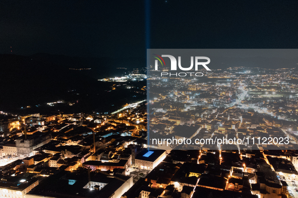 A blue light beam faced to the sky is seen in an aerial view in L'Aquila, Italy, on April 5th, 2024. On April 6th L'Aquila will commemorate...