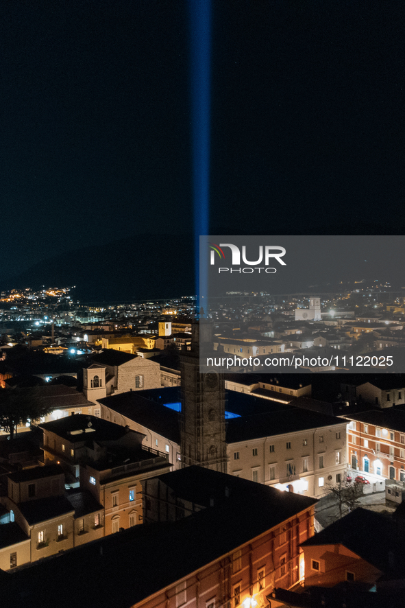 A blue light beam faced to the sky is seen in an aerial view in L'Aquila, Italy, on April 5th, 2024. On April 6th L'Aquila will commemorate...