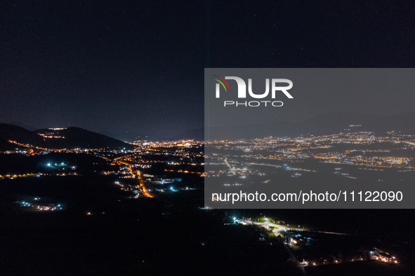 A blue light beam faced to the sky is seen in an aerial view in L'Aquila, Italy, on April 5th, 2024. On April 6th L'Aquila will commemorate...